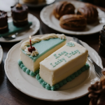 A beautifully decorated celebration cake from Lacey Cakes, showcasing handcrafted details and vibrant colors